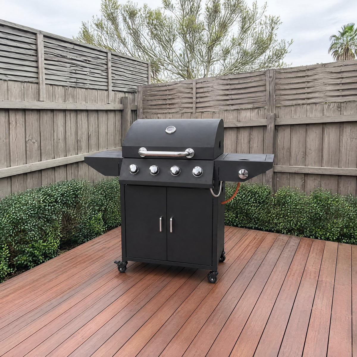 4-Burner Gas BBQ with Side Burner, Black - in an Australian backyard